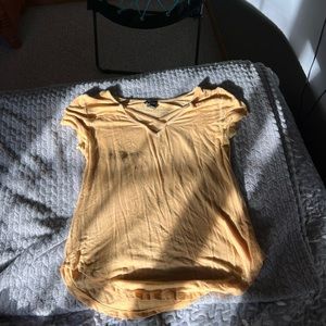 Pretty golden shirt with little cross over in front